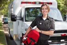 EMS standing in front of an ambulance smiling
