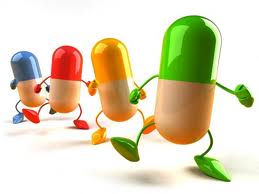 Image of four different colored pills dancing in a line.