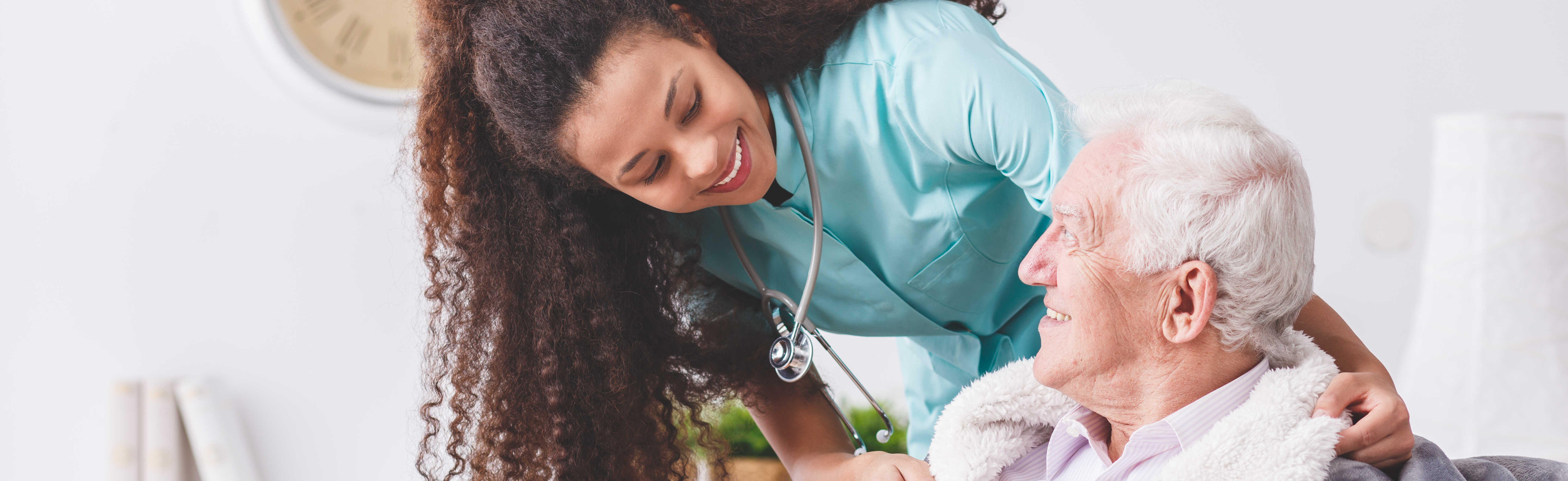 caregivers assisting an elderly patient