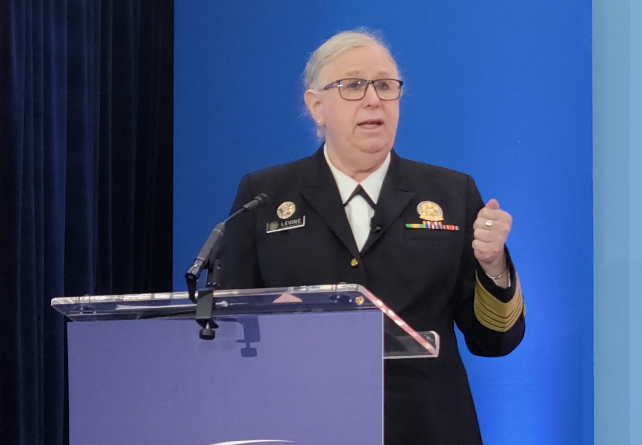 Woman in uniform standing and talking at podium