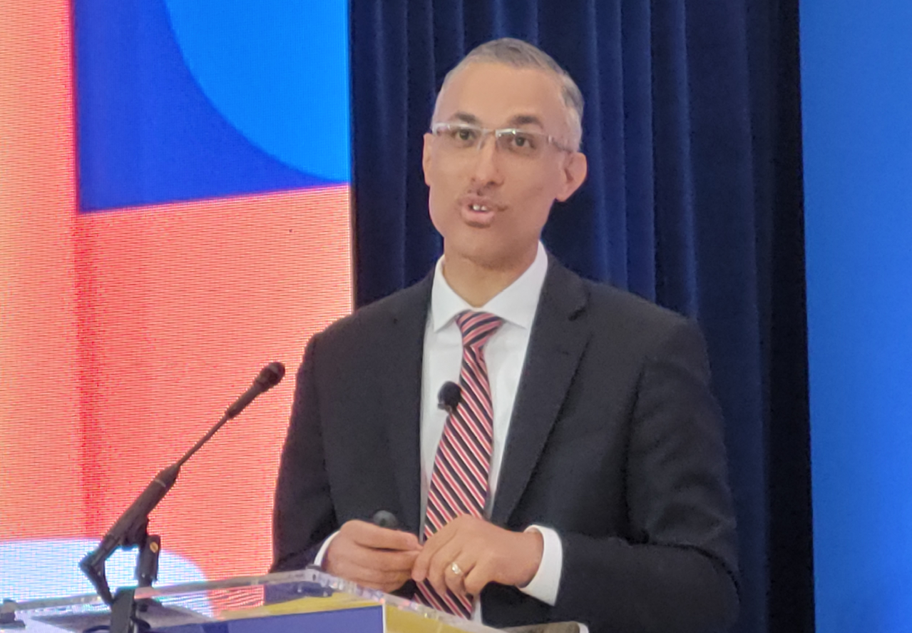 Man standing at a podium speaking