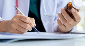 Doctor with prescription bottle in hand