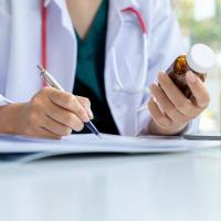 Doctor with prescription bottle in hand