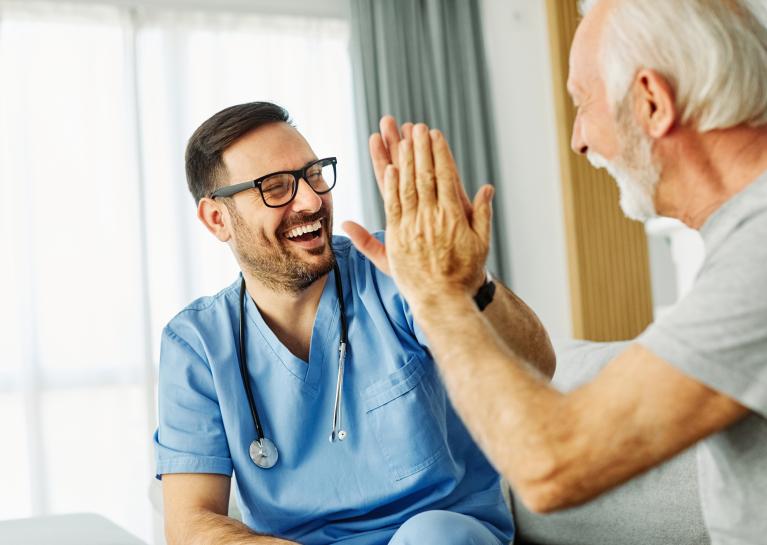 A medical professional high-fives a patient