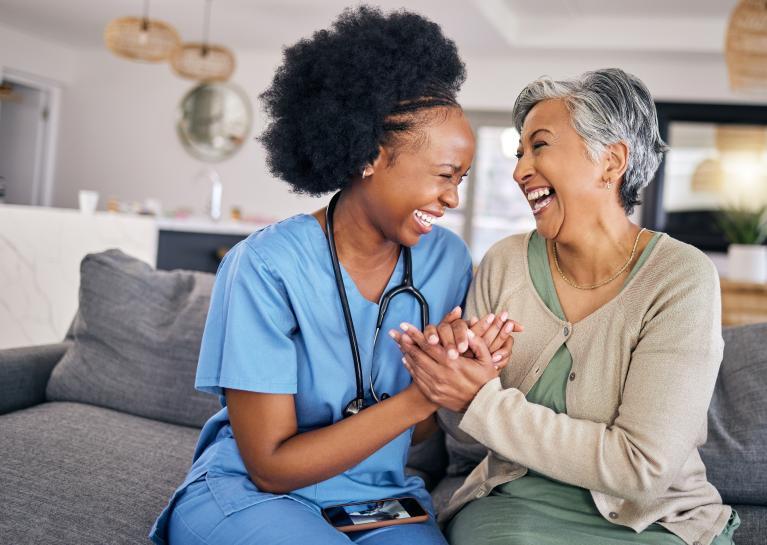 Medical professional and patients holding hands and laughing